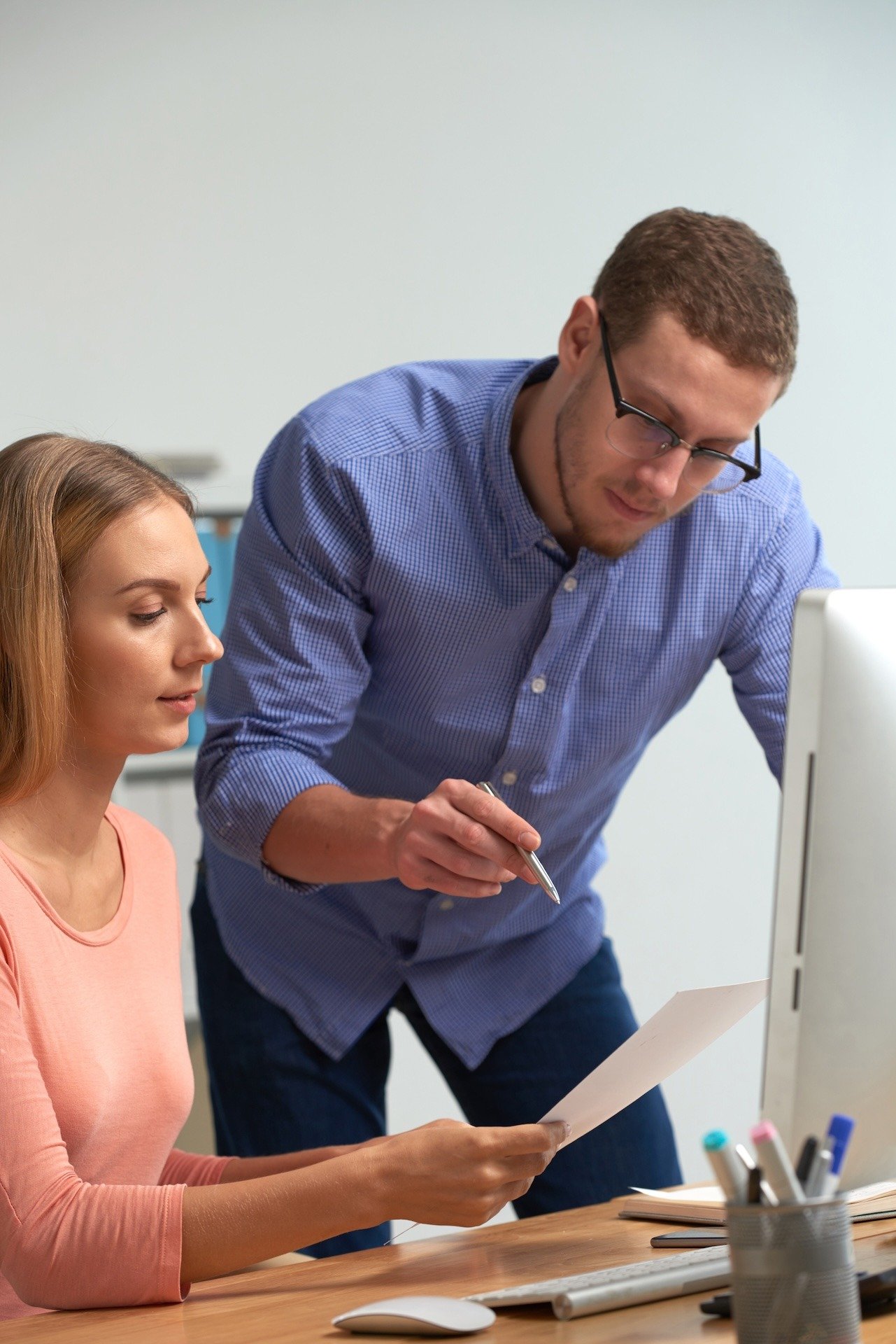 Image of two colleagues reviewing IT policies during training session